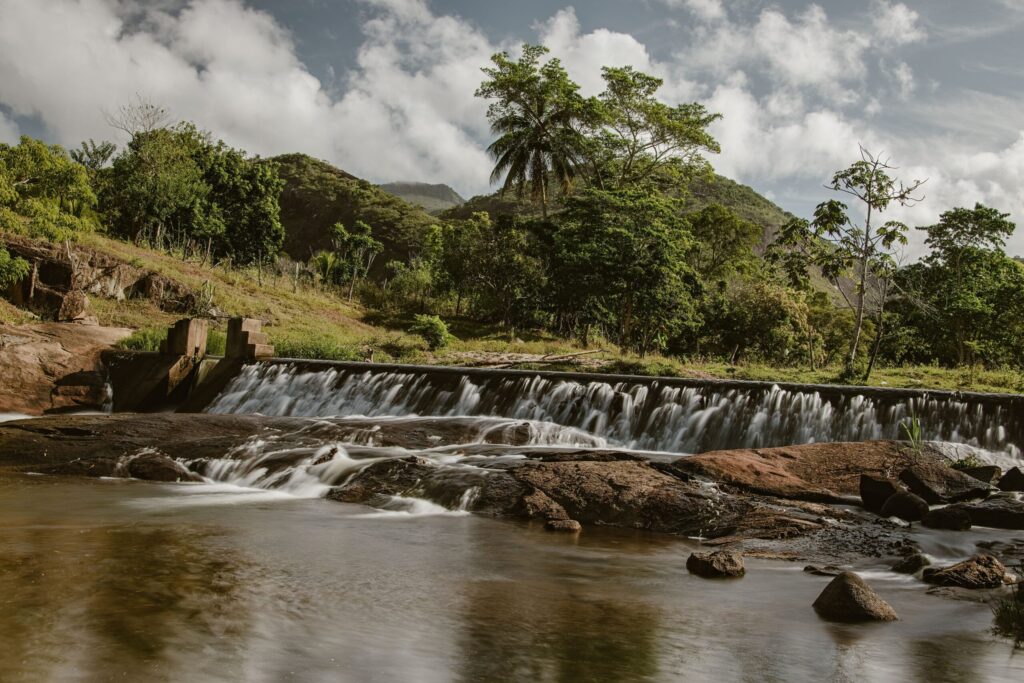 A waterfall cascading through dense green tropical rainforest foliage