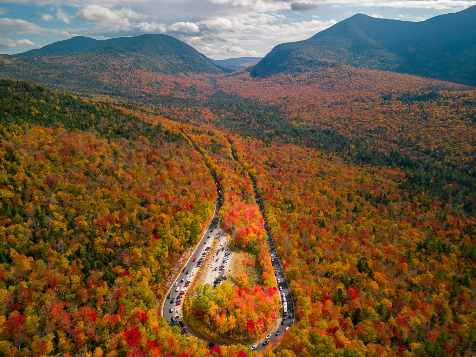 A winding road curving through a wooded landscape.