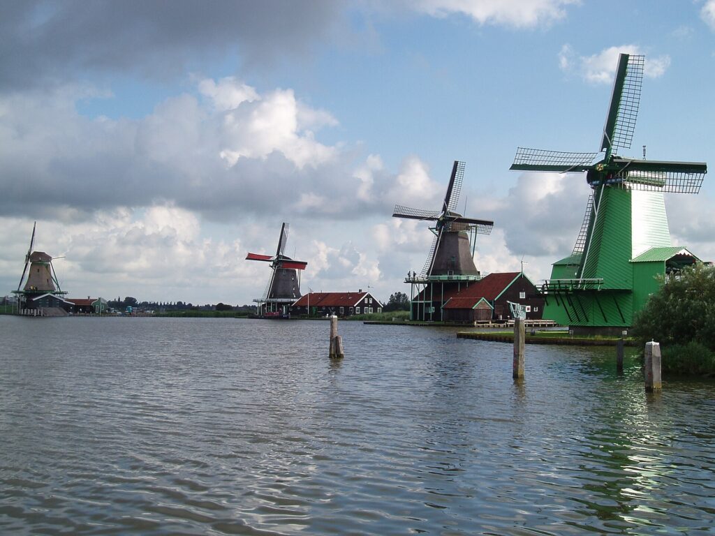 Wooden windmills beside the water at Zaanse Schans in the Netherlands