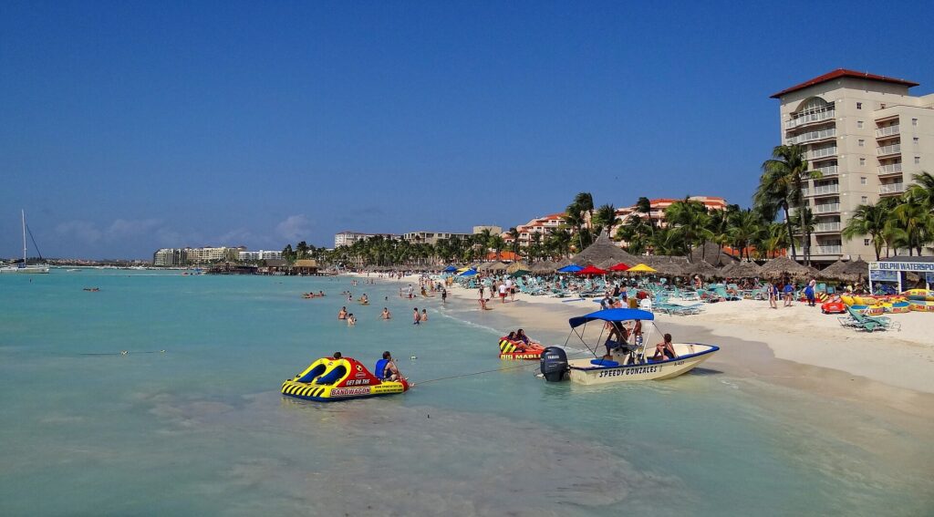 Palm Beach on Aruba with white sand and resort buildings along the shore