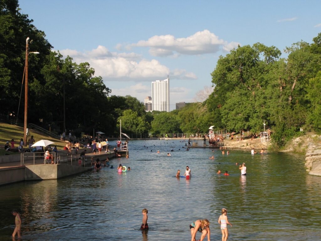 Barton Springs Pool and its grassy banks in Zilker Park, Austin, Texas