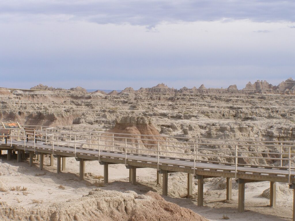 Boardwalk of the Door Trail crossing pale badlands formations in Badlands National Park