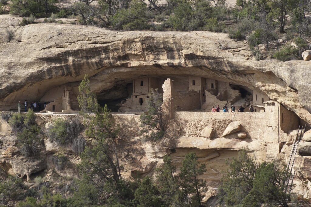 Balcony House stone rooms and a ladder under a sandstone overhang at Mesa Verde National Park