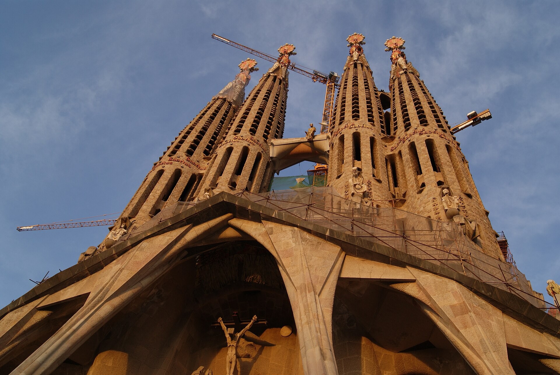Towers of the Sagrada Família basilica rising above Barcelona rooftops in daylight