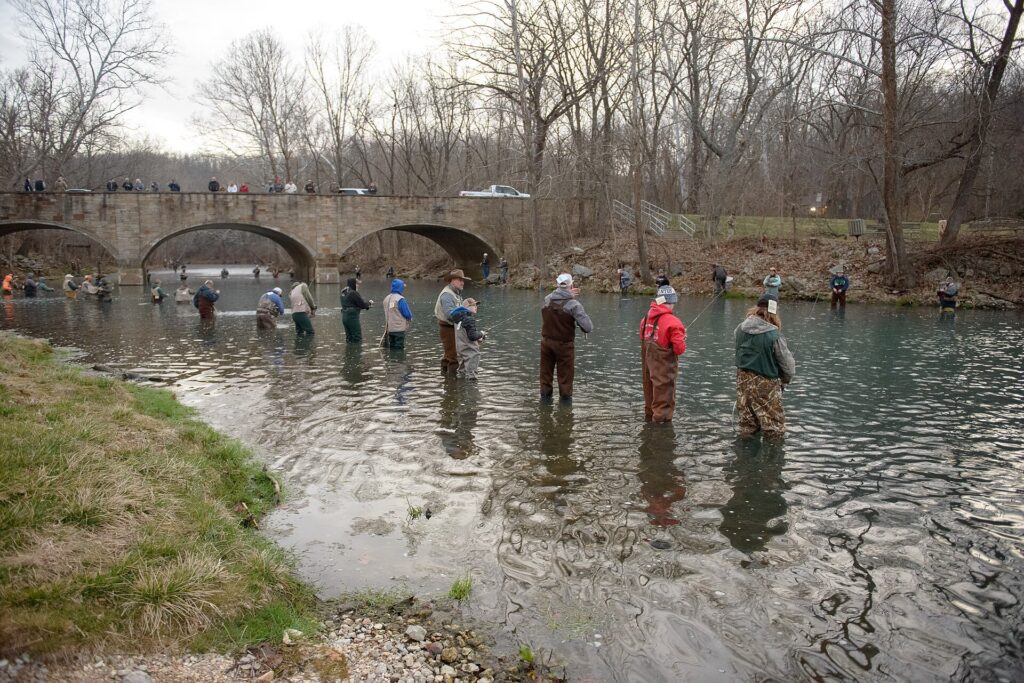 Anglers wading the spring branch below the stone bridge at Bennett Spring State Park, Missouri