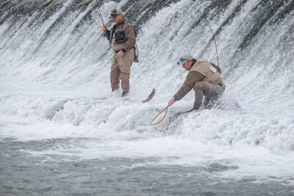 Two anglers working the dam spillway at Bennett Spring State Park, Missouri