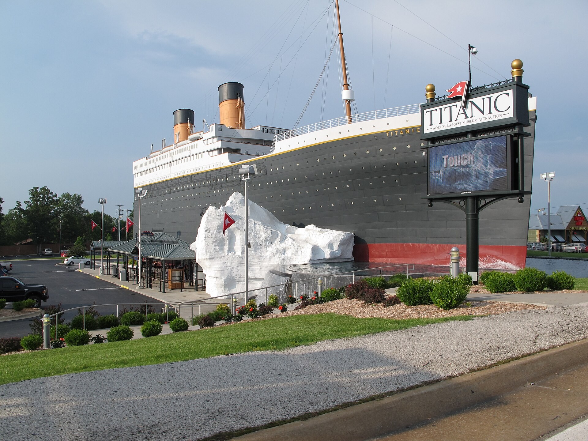 Titanic Museum Attraction building shaped like the ship, with a white iceberg replica beside it in Branson, Missouri