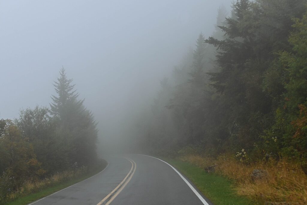 Fog hanging over a curve of the Blue Ridge Parkway in Yancey County, North Carolina