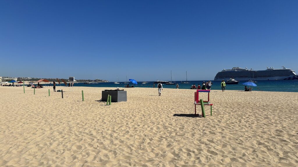 Sand at Medano Beach with a cruise ship anchored in the bay, Cabo San Lucas
