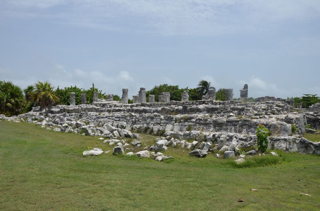 Low stone Maya structure on a grassy platform at the El Rey ruins in Cancun