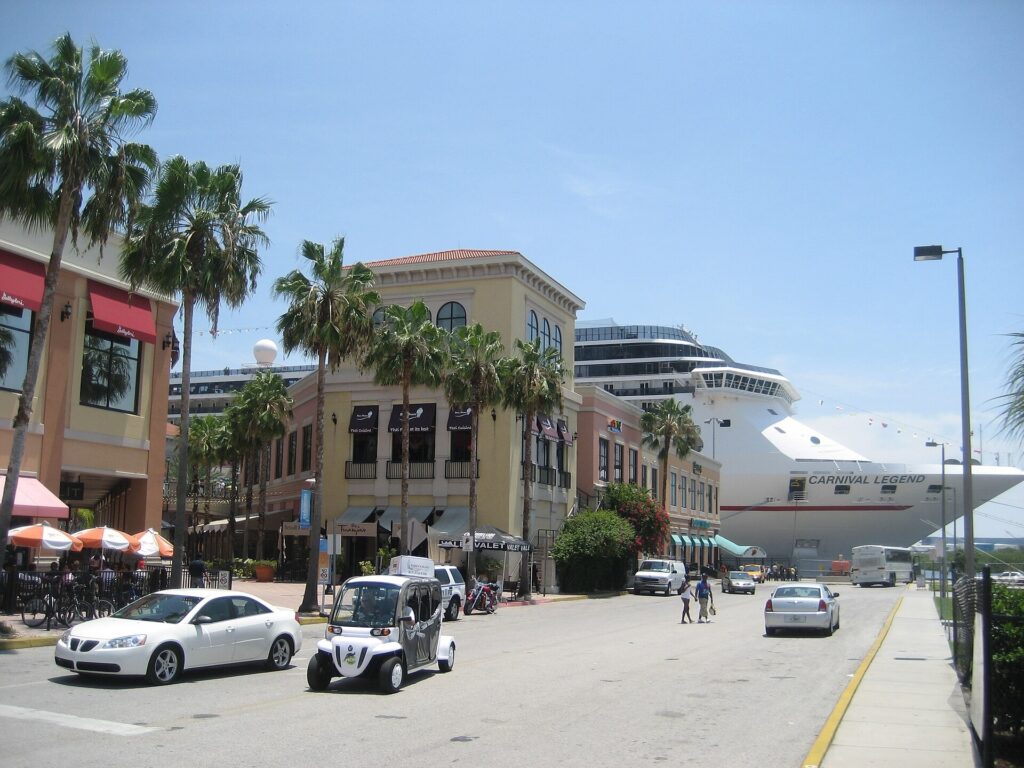 Carnival Legend cruise ship docked behind buildings and palm trees along Channelside Drive in Tampa