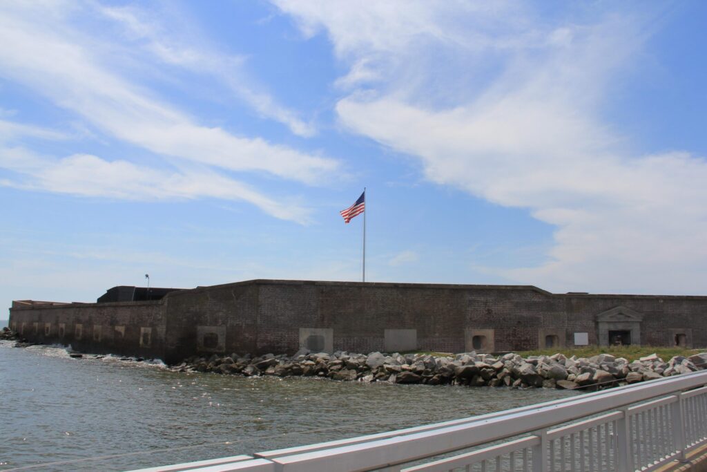 Brick walls of Fort Sumter rising from the water in Charleston Harbor