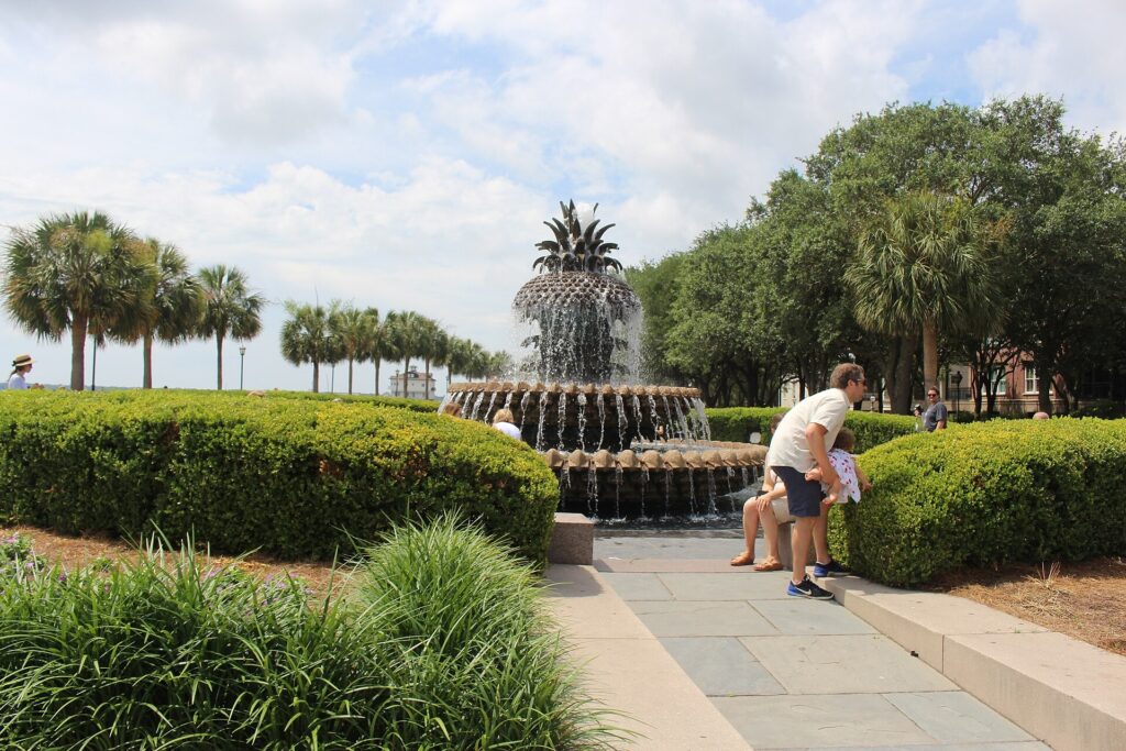 Pineapple Fountain at Waterfront Park in Charleston, South Carolina, with palms and clipped hedges