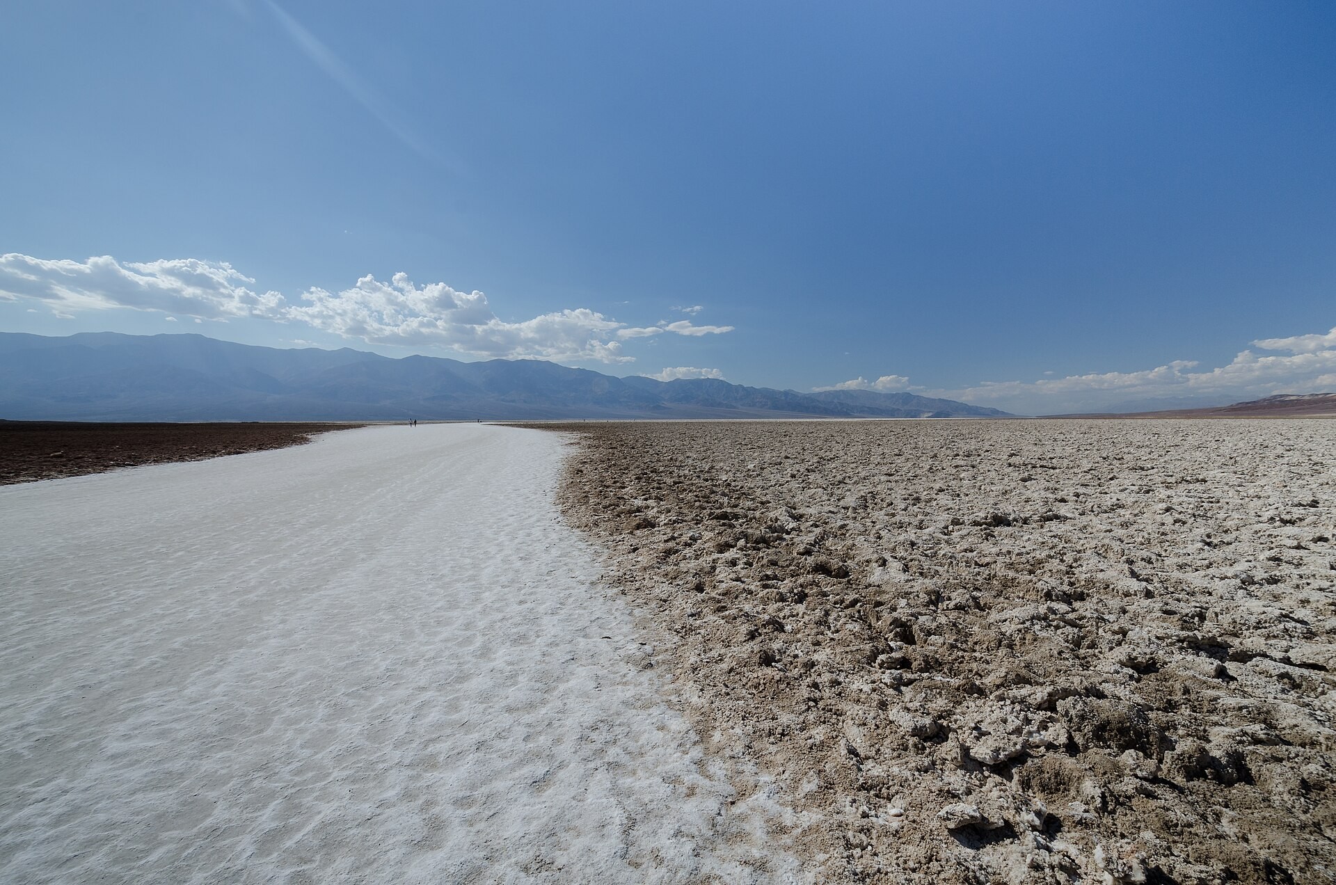 Salt deposits forming a wide pale path across the Badwater Basin salt flat in Death Valley National Park