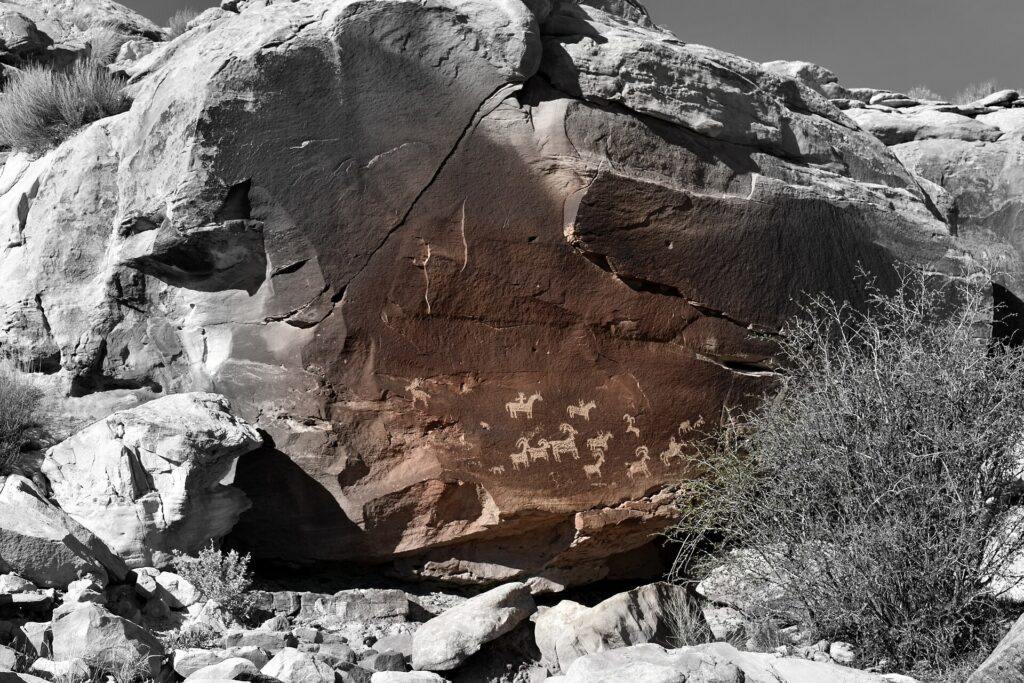 Ute petroglyph panel carved into a sandstone wall near Wolfe Ranch in Arches National Park