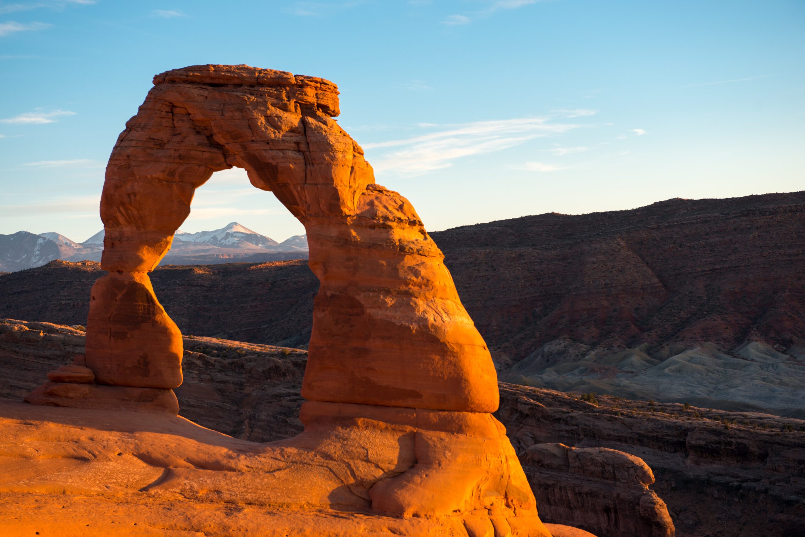 Delicate Arch standing on a slickrock rim in Arches National Park
