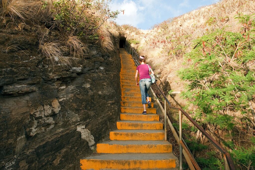 Visitors climbing the first staircase on the Diamond Head summit trail on Oahu