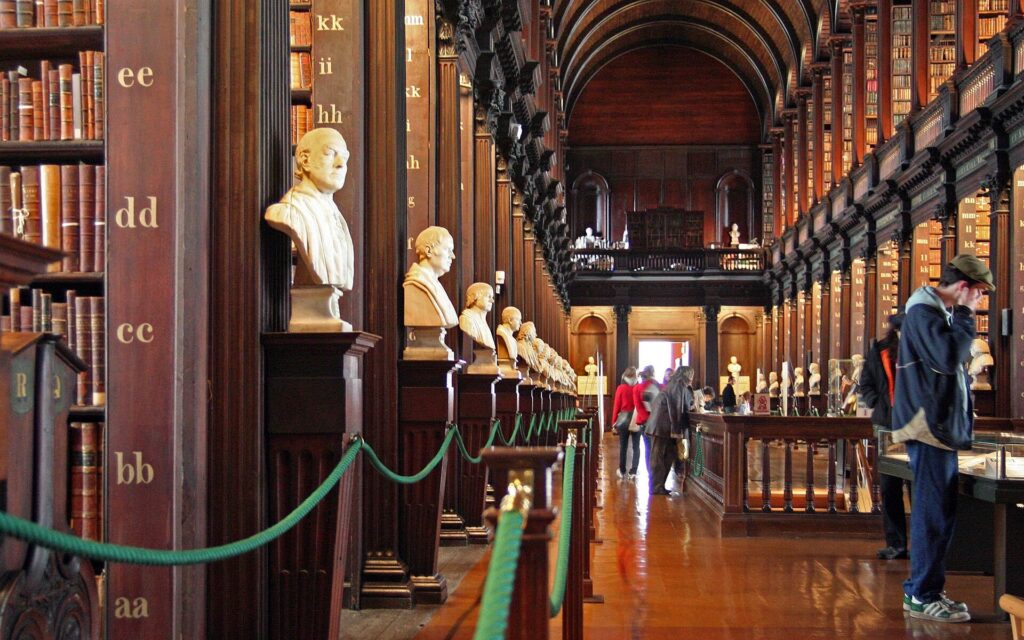 The Long Room of the Old Library at Trinity College Dublin with its tall bookshelves and marble busts