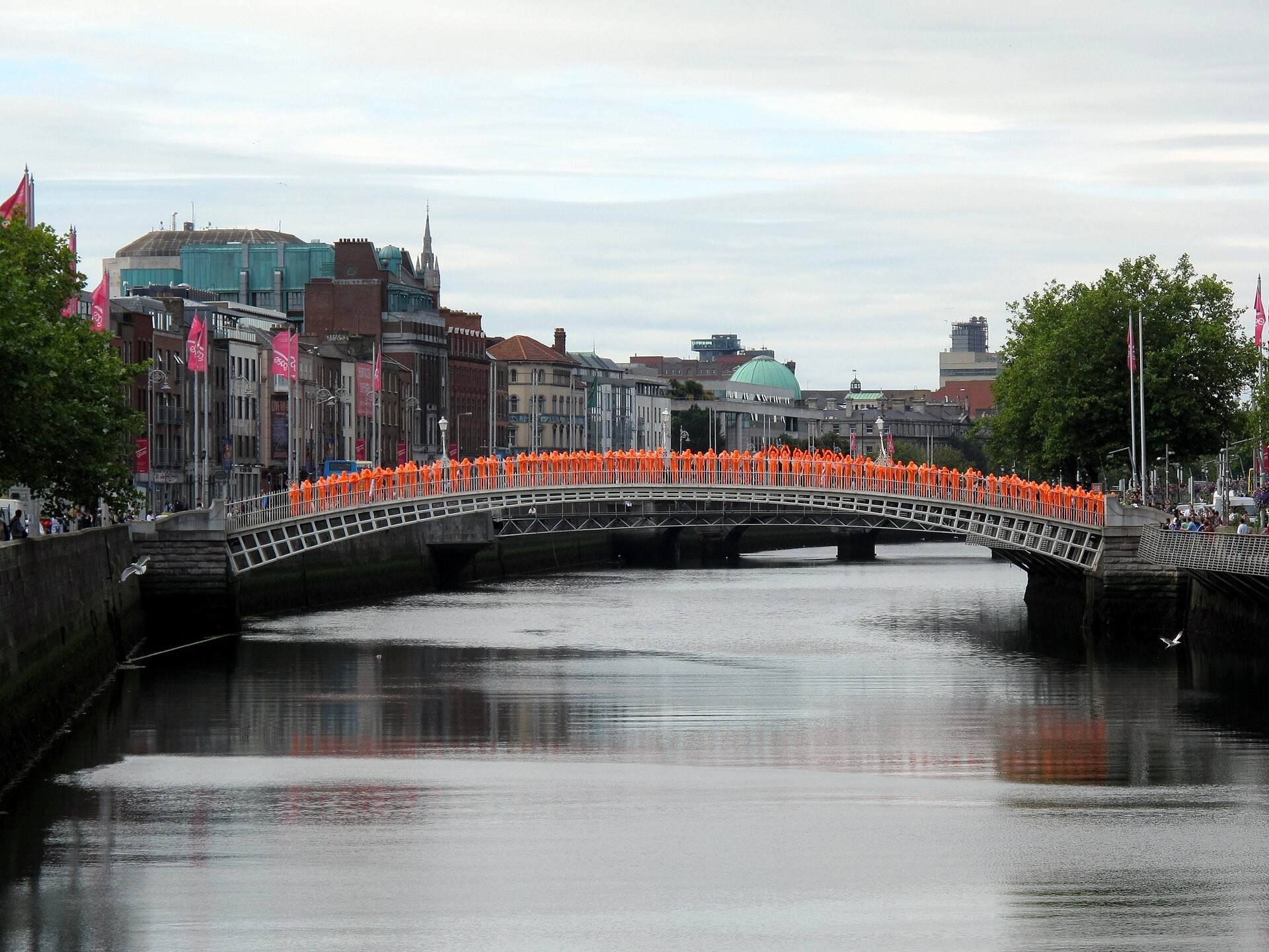 Ha'penny Bridge over the River Liffey in Dublin with pedestrians crossing