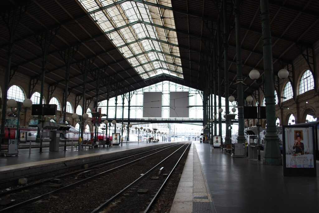 Platforms under the glass-and-iron roof of Gare du Nord in Paris