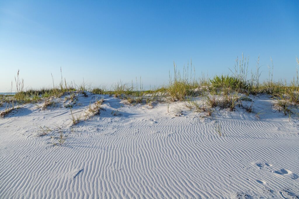 A white sand beach with dunes and wind ripples on Santa Rosa Island at Pensacola Beach, Florida