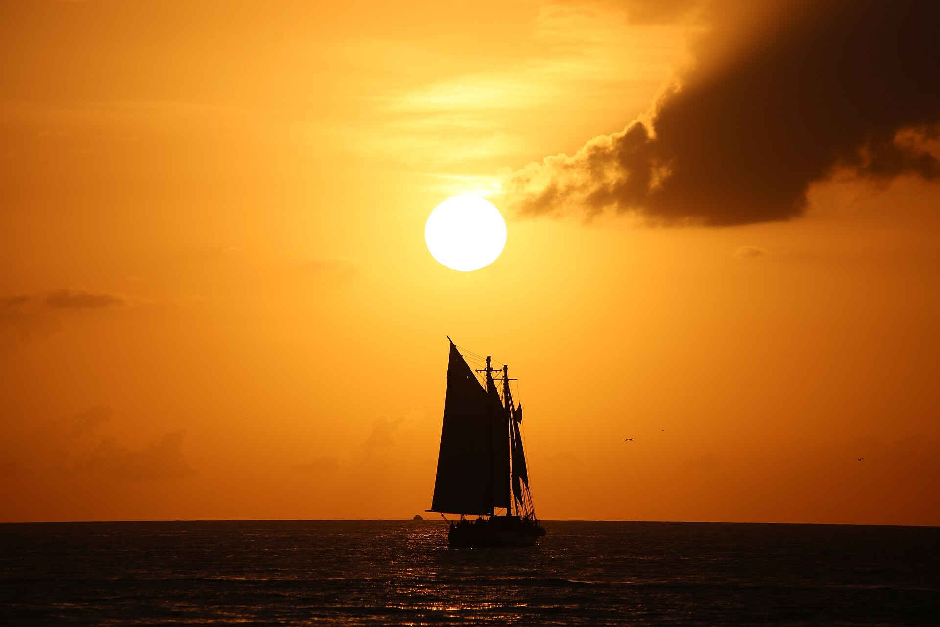 Orange sunset sky over the water at Mallory Square in Key West, Florida