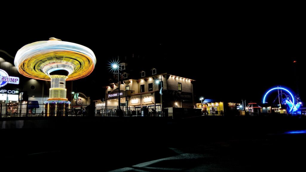 Galveston Island Historic Pleasure Pier rides lit up at night along the Seawall