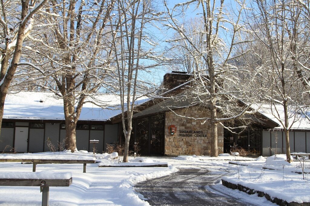 Snow-covered Sugarlands Visitor Center building and picnic tables near Gatlinburg in Great Smoky Mountains National Park
