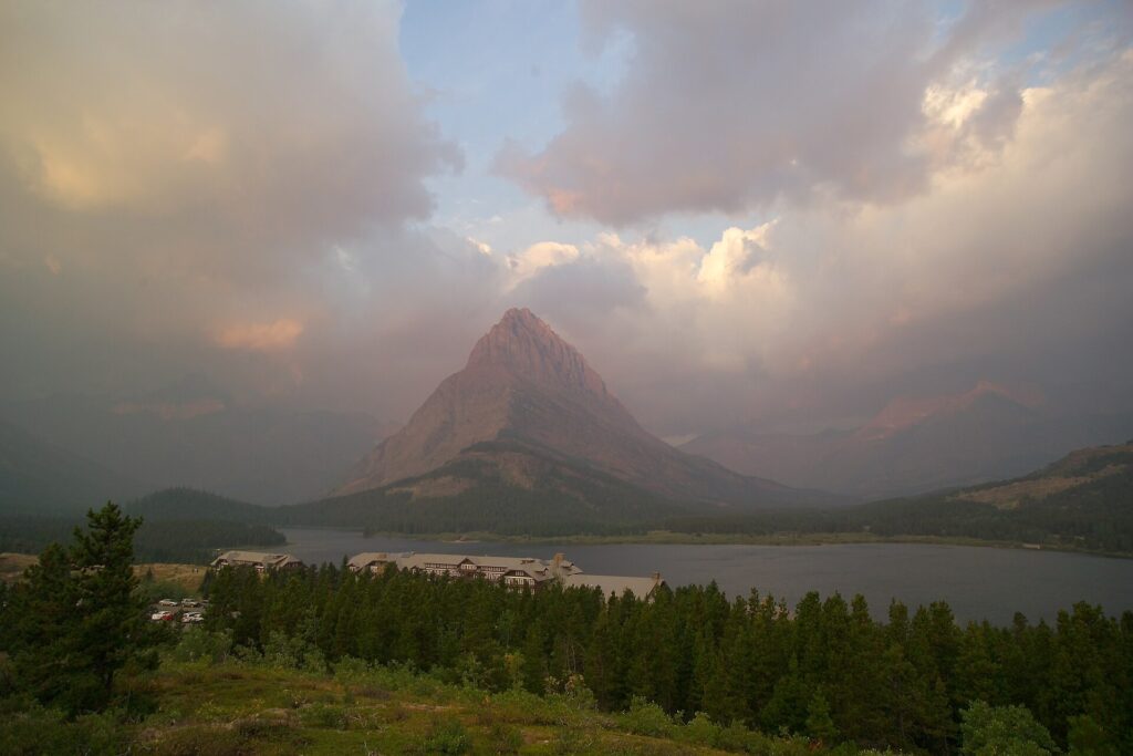 Grinnell Point rising above Swiftcurrent Lake under heavy clouds at Many Glacier, Glacier National Park