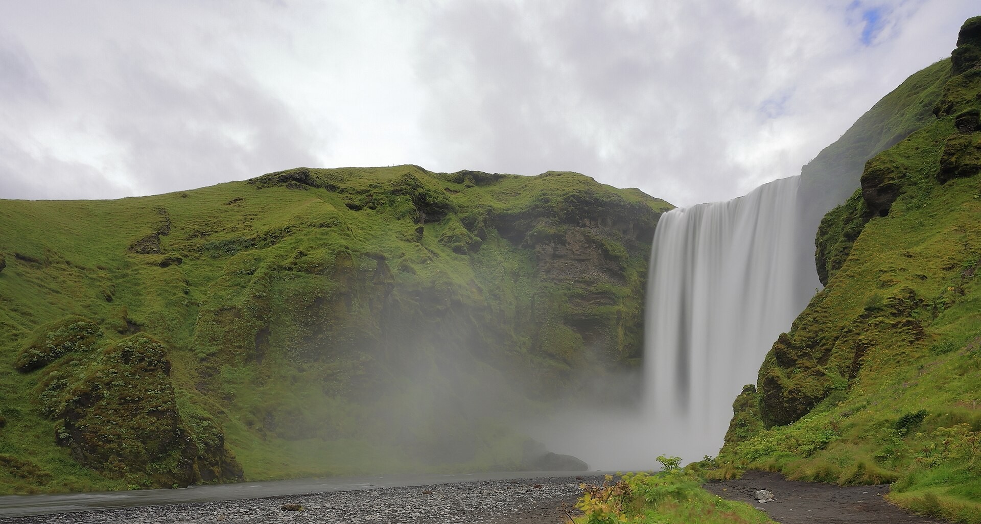 Skógafoss waterfall dropping over a cliff in South Iceland