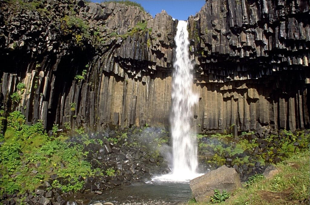 Svartifoss waterfall falling past dark basalt columns in Skaftafell, Iceland