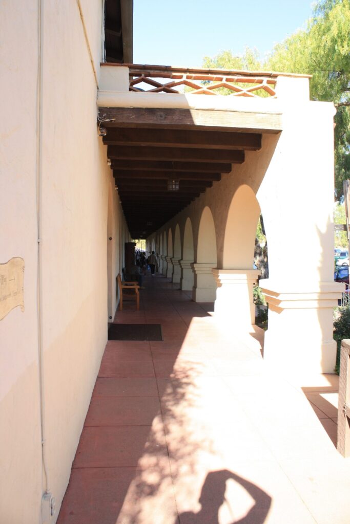 Arched covered walkway along the side of Mission Santa Ines in Solvang, California