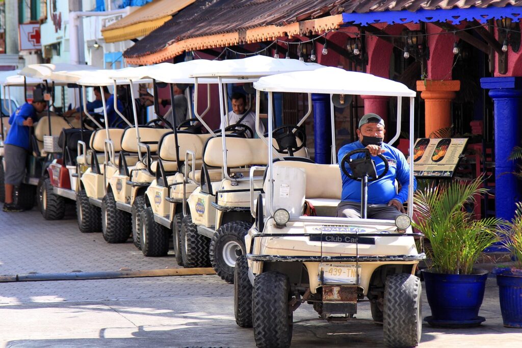 Golf carts lined up at a rental shop on Isla Mujeres