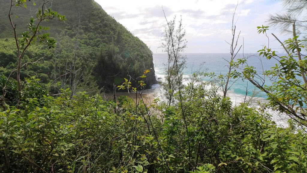 Hanakapiai Beach below green cliffs on the Kalalau Trail, Napali Coast, Kauai