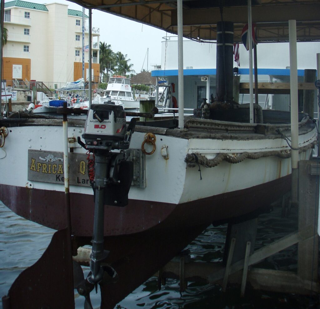 The African Queen steam launch on its lift at the marina in Key Largo, with its name board on the hull