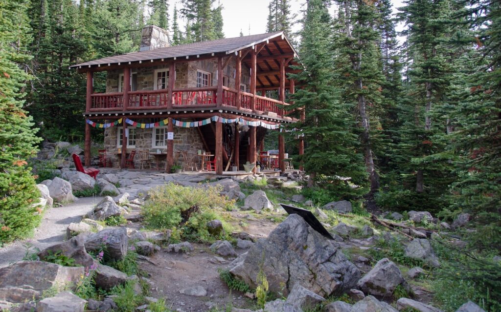 The wooden Plain of Six Glaciers teahouse among spruce trees and rocks near Lake Louise