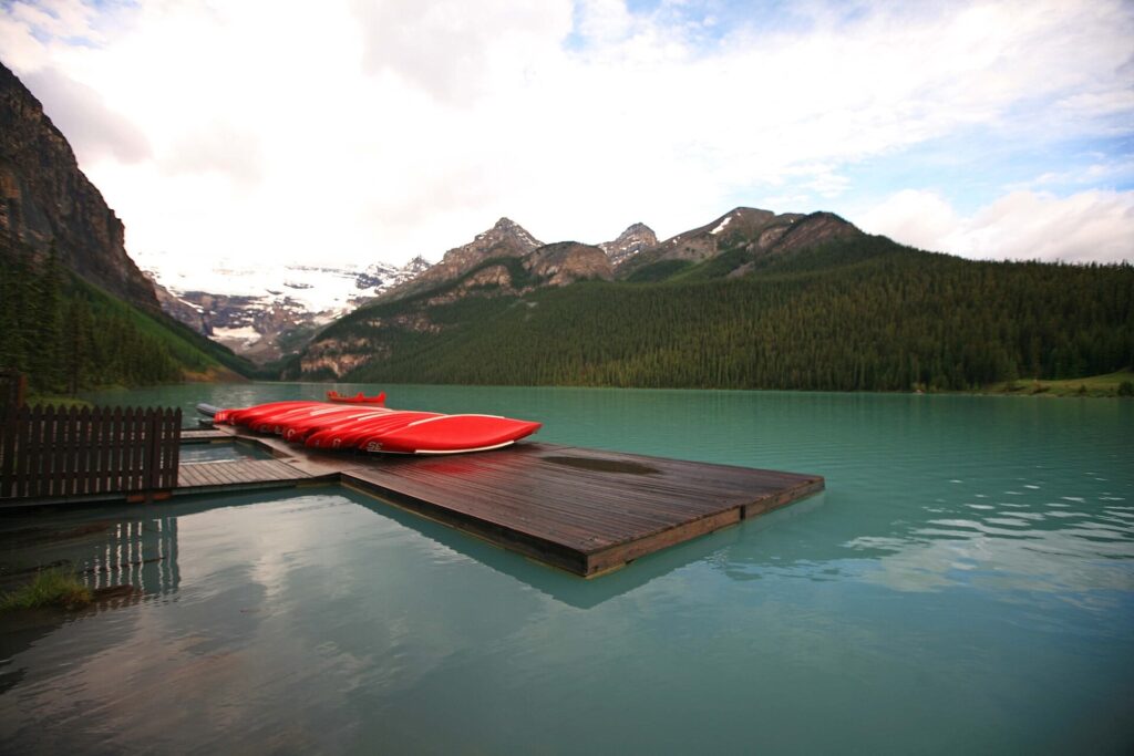 Red canoes tied at a dock on Lake Louise in Banff National Park