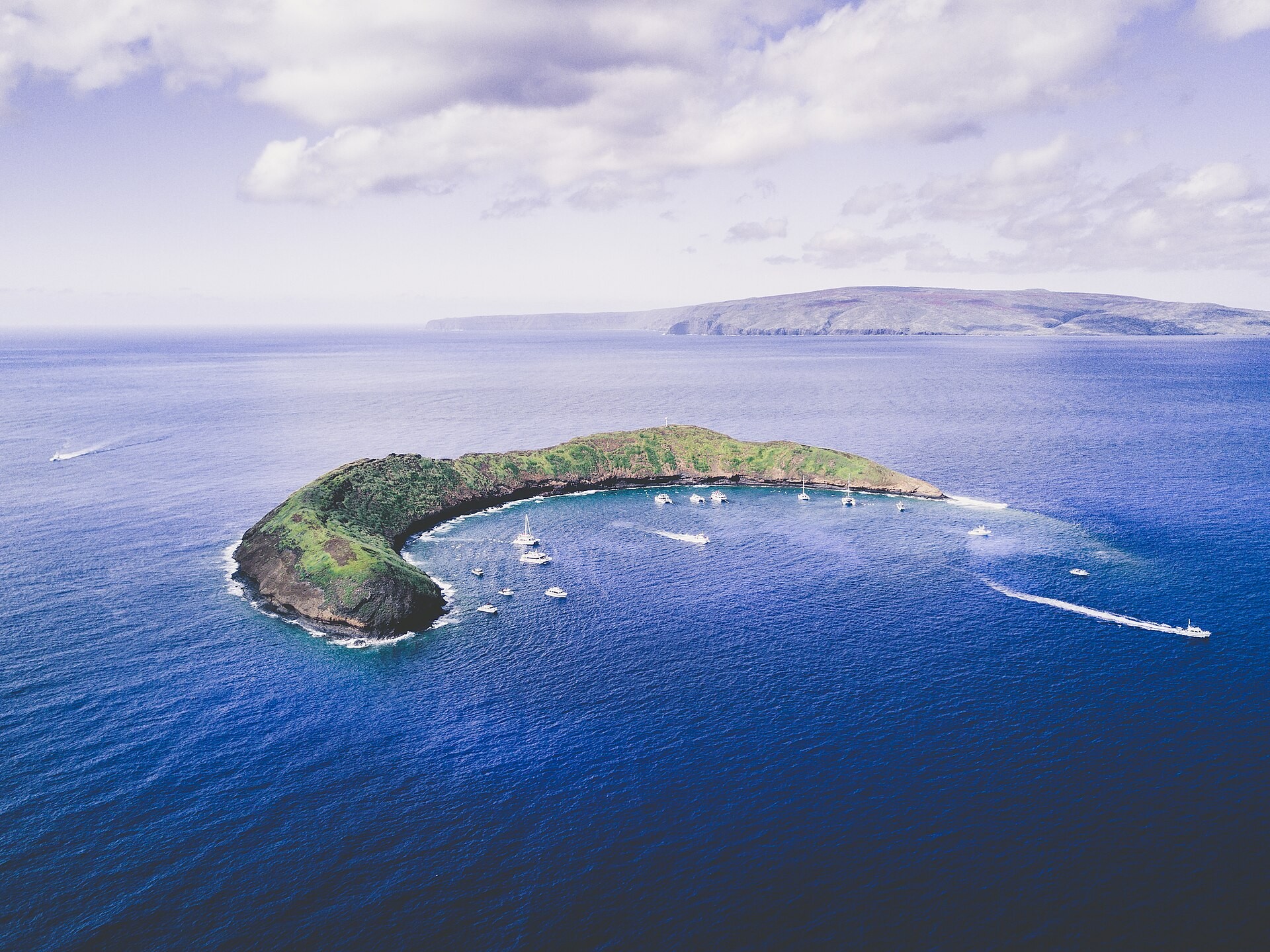 Snorkelers in the water at Molokini Crater off Maui