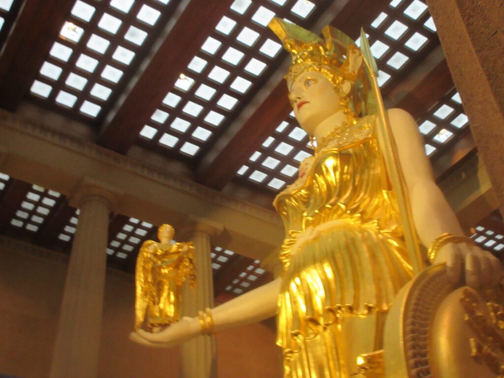 Gilded Athena statue under the coffered ceiling inside the Nashville Parthenon
