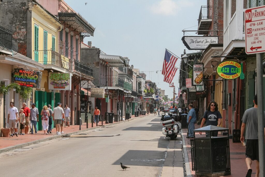 Balconied buildings and street signs along Bourbon Street in the French Quarter of New Orleans