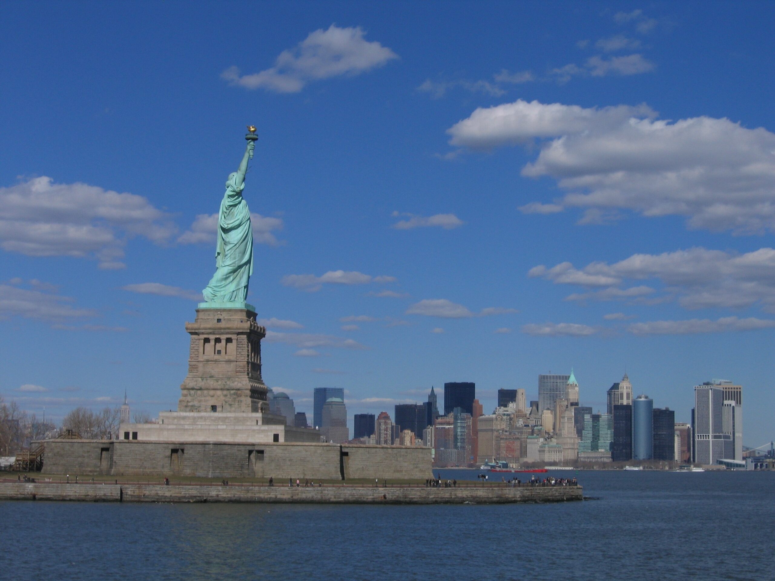 The Statue of Liberty on Liberty Island with the Lower Manhattan skyline behind it