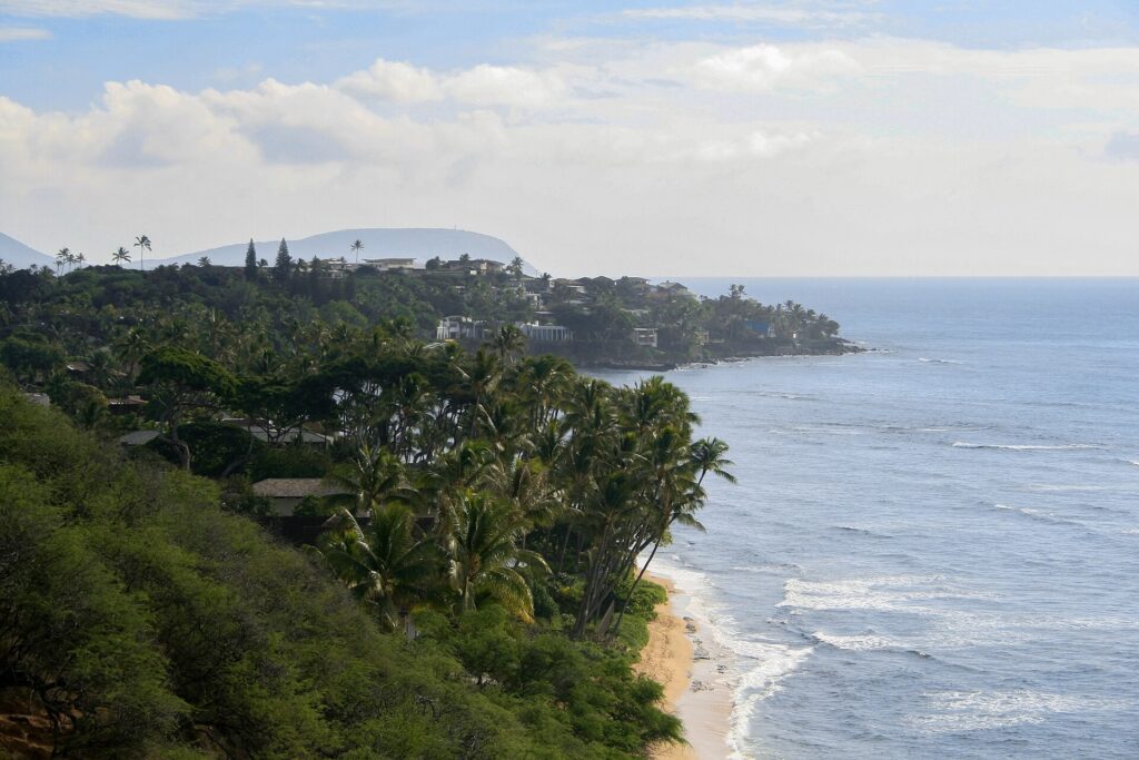 North Shore coastline of Oahu with trees, surf and shoreline seen from above Sunset Beach
