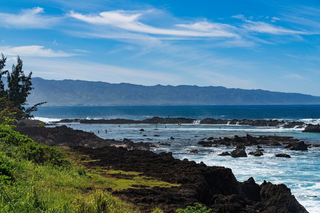Dark lava rock shoreline and breaking waves near Shark’s Cove on Oahu’s North Shore