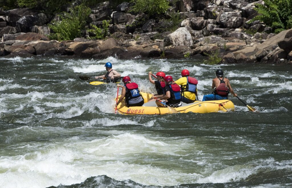 A raft crew paddling through a rocky rapid on the Ocoee River in Tennessee