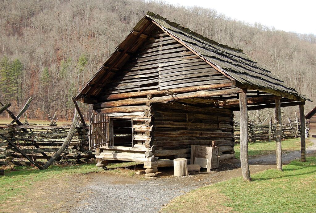 Log corn crib with an attached shed roof and a split-rail fence at the Mountain Farm Museum near Oconaluftee
