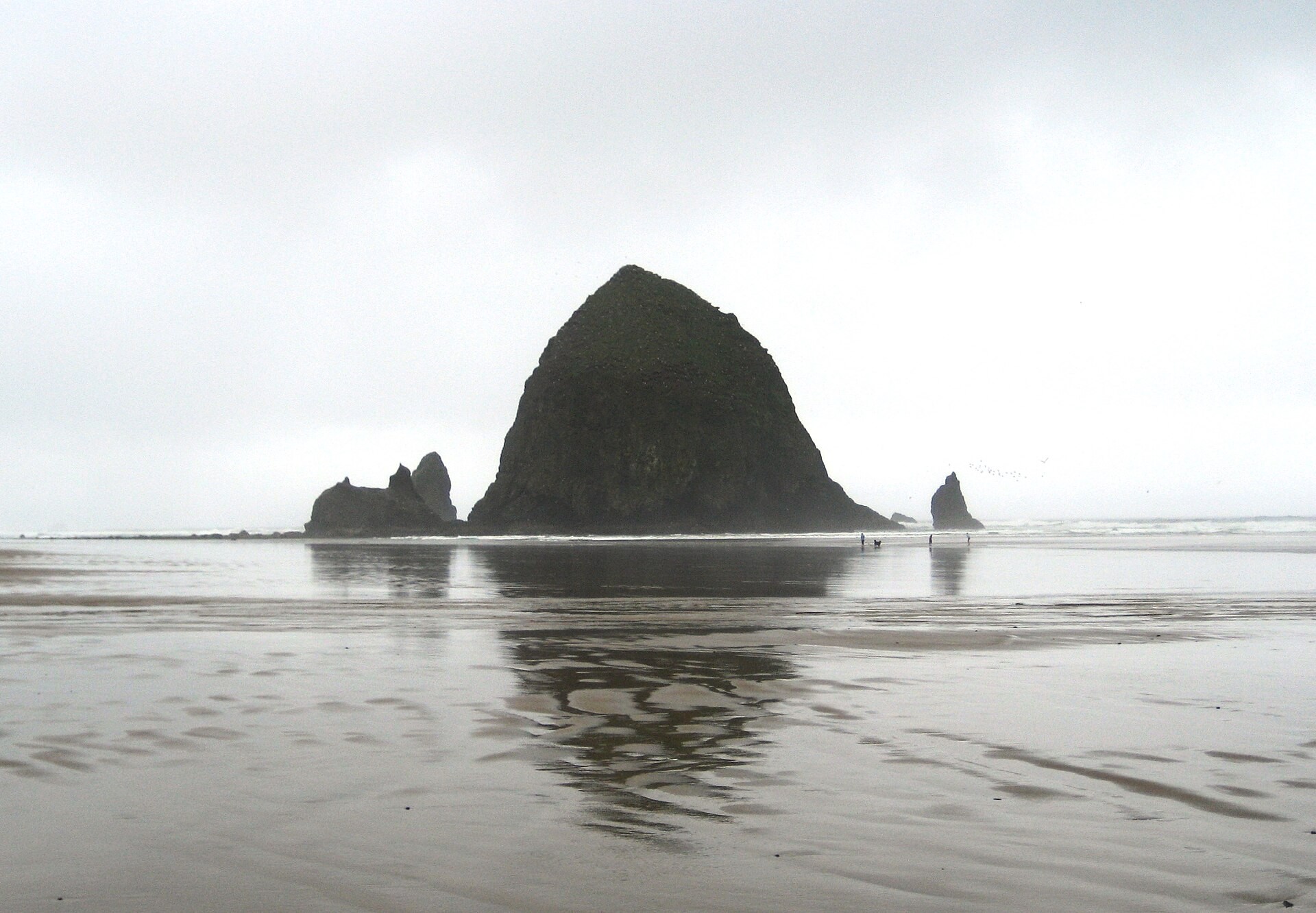 Haystack Rock rising from the beach at Cannon Beach, Oregon, seen from the north