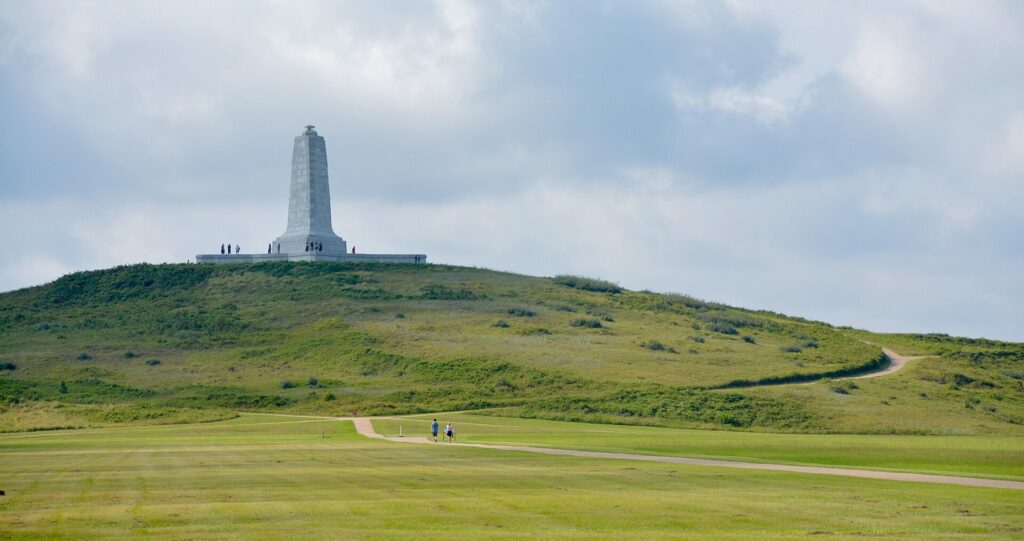 Granite Wright Brothers Monument on Kill Devil Hill above grass at Wright Brothers National Memorial