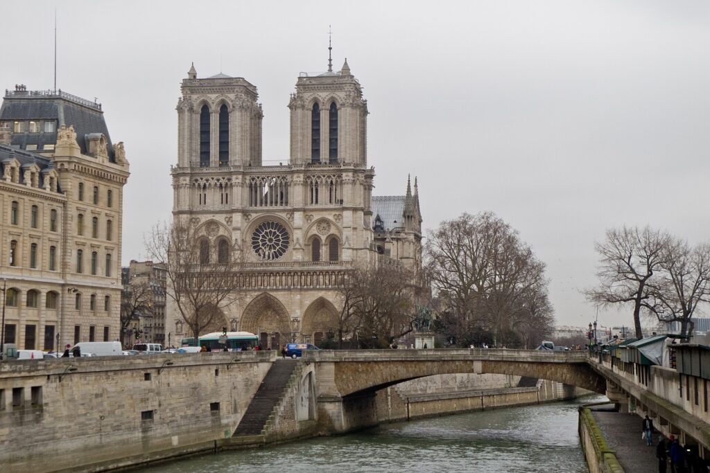 West facade of Notre-Dame de Paris and the Petit Pont beside the Seine
