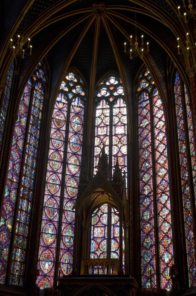 Tall stained glass windows inside the upper chapel of Sainte-Chapelle in Paris