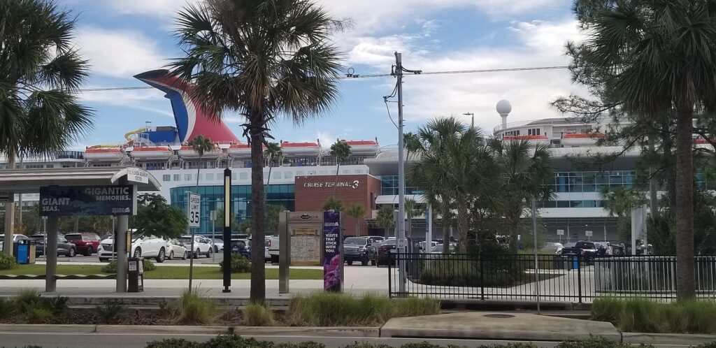 Port Tampa Bay Cruise Terminal 3 with a ship funnel behind palm trees on Channelside Drive